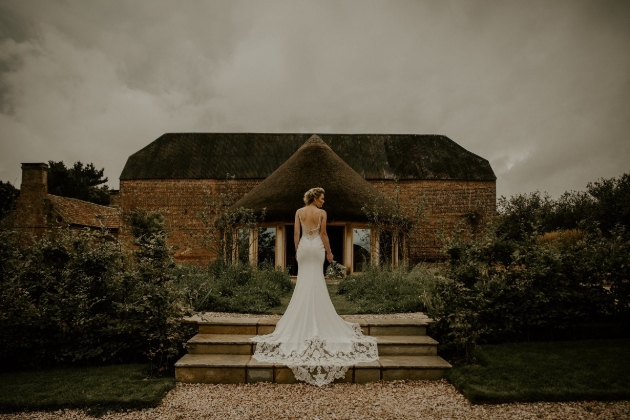 bride on steps with barn in background