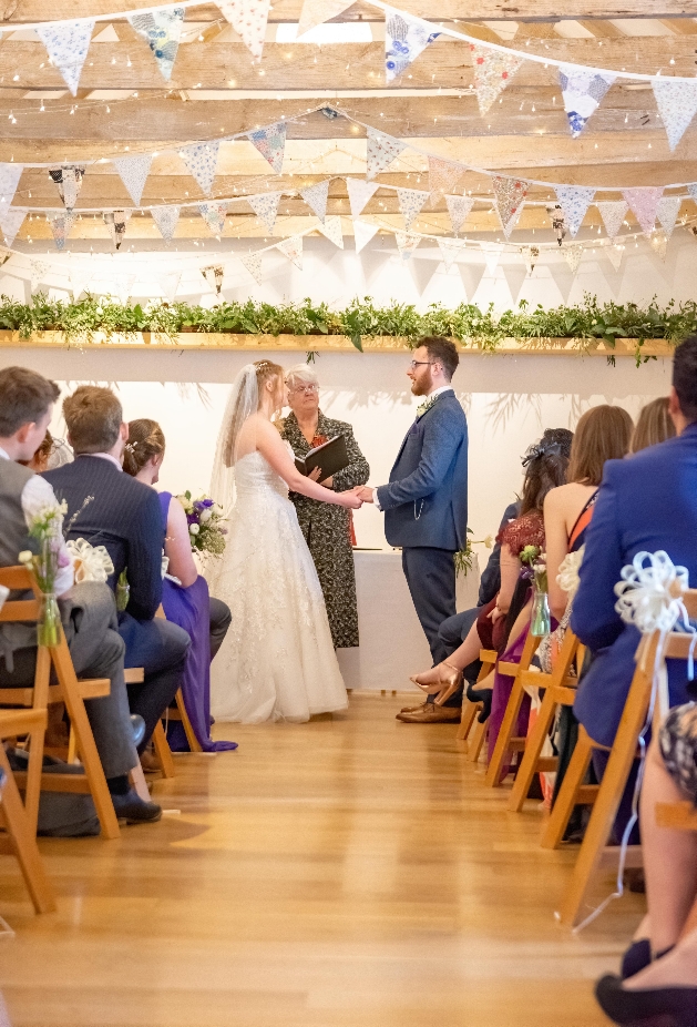 Couple hold hands exchanging vows