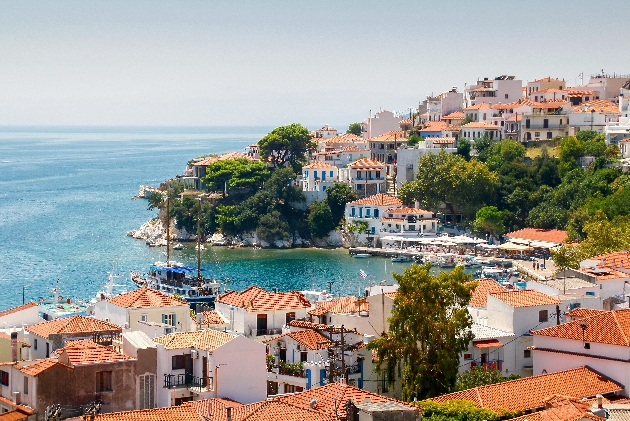 greek island town, with sea views and a steam boat in the water