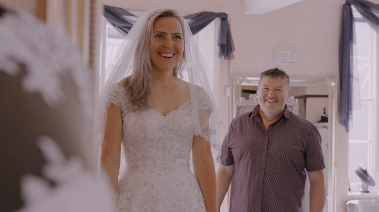 A bride in her wedding dress, veil and hair accessory
