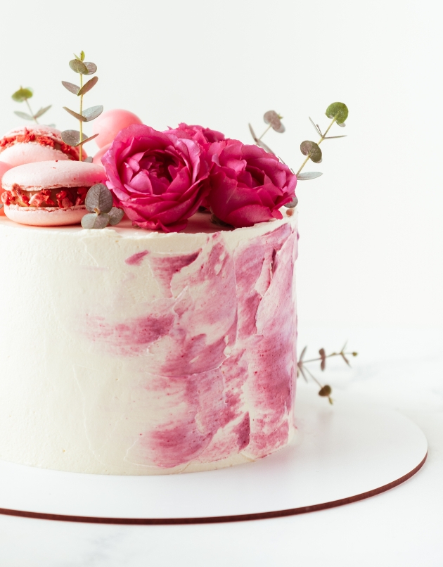 cake with paint marks and flowers on top