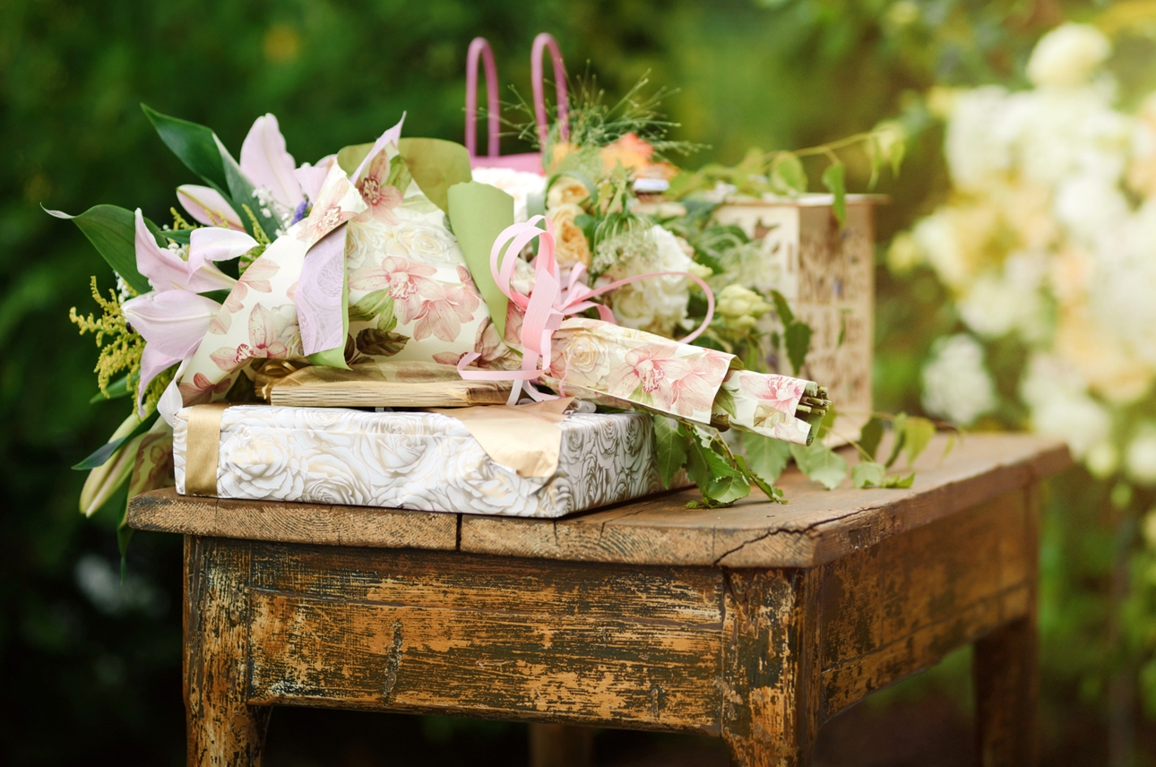 present wrapped in pretty paper on a rustic wooden table