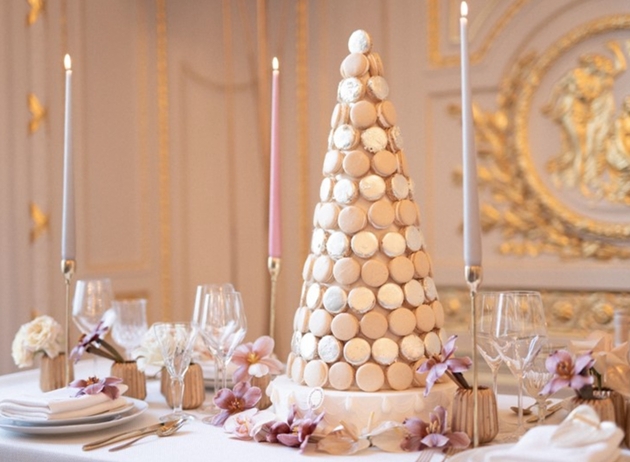 gold macaron tower laid out on a dessert table