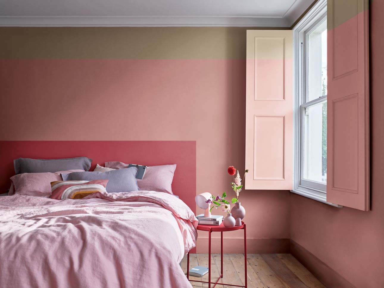 bedroom painted in pink and beige with pink decor and accessories