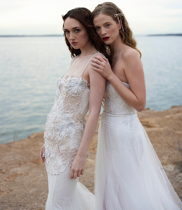 two models in dresses on beach. One in spaghetti straps with floral details and colourful touches