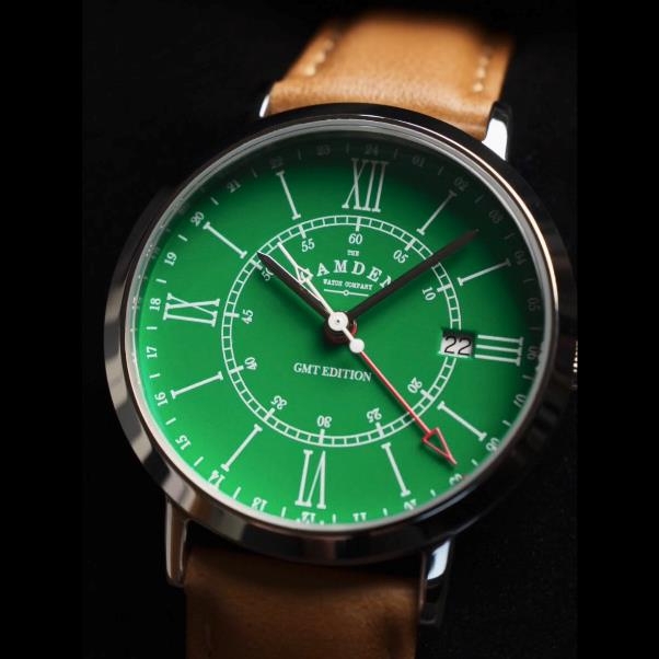 A green watch with a brown strap