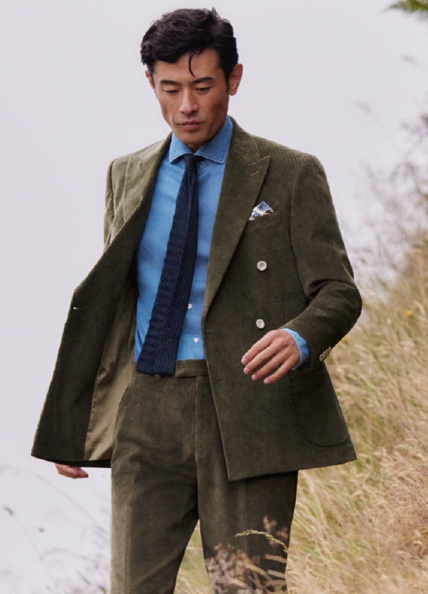 A man wearing a green suit