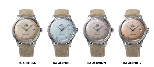 Four watches with brown straps and pastel-coloured faces