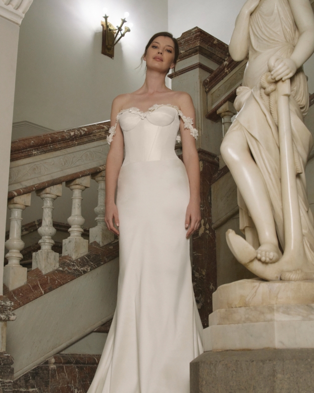 woman in plain ehite dress with lace sleeves 