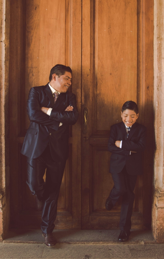father and son posing in doorway