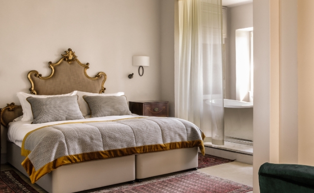Inside shot of elegant bedroom with view of bath tub 