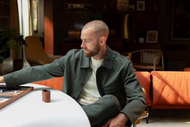 man in green casual suit playing a board game 